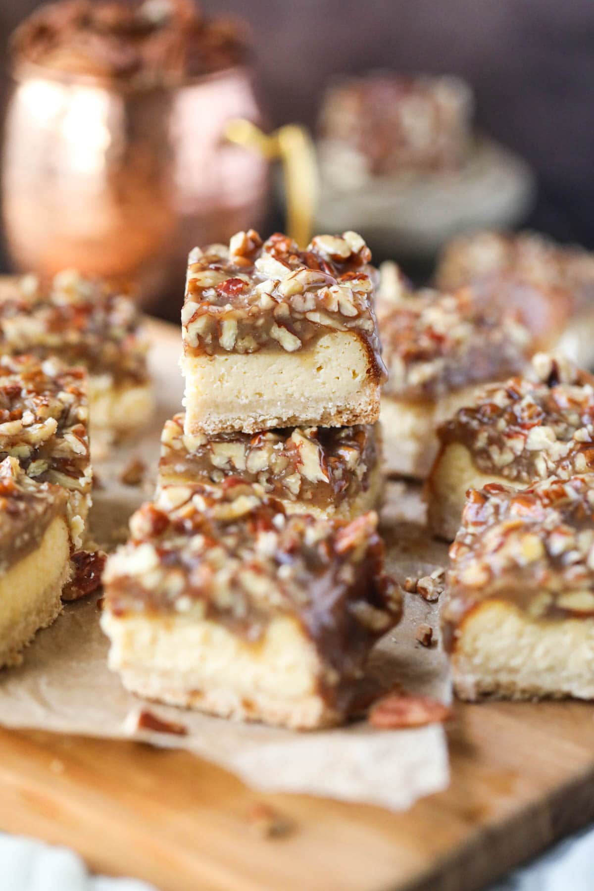 pecan pie cheesecake bars on parchment paper.