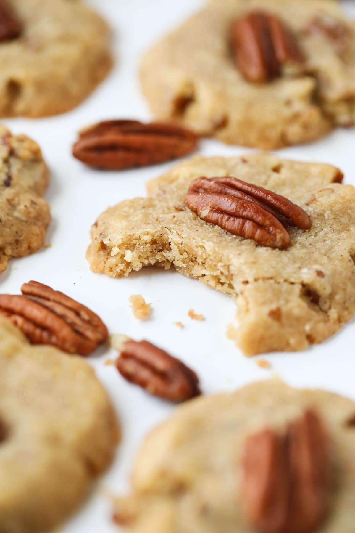 pecan sandies lying on a white surface.