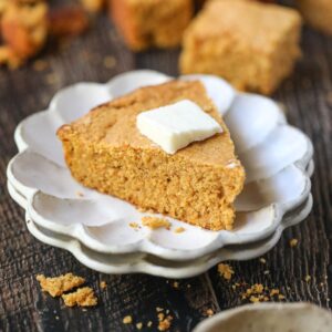 slice of sweet potato cornbread on a white plate.
