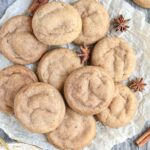 chai cookies spread out on parchment paper.