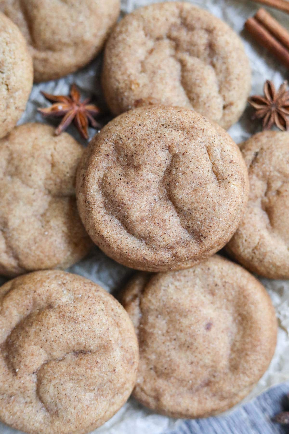 chai cookies spread out on parchment paper.