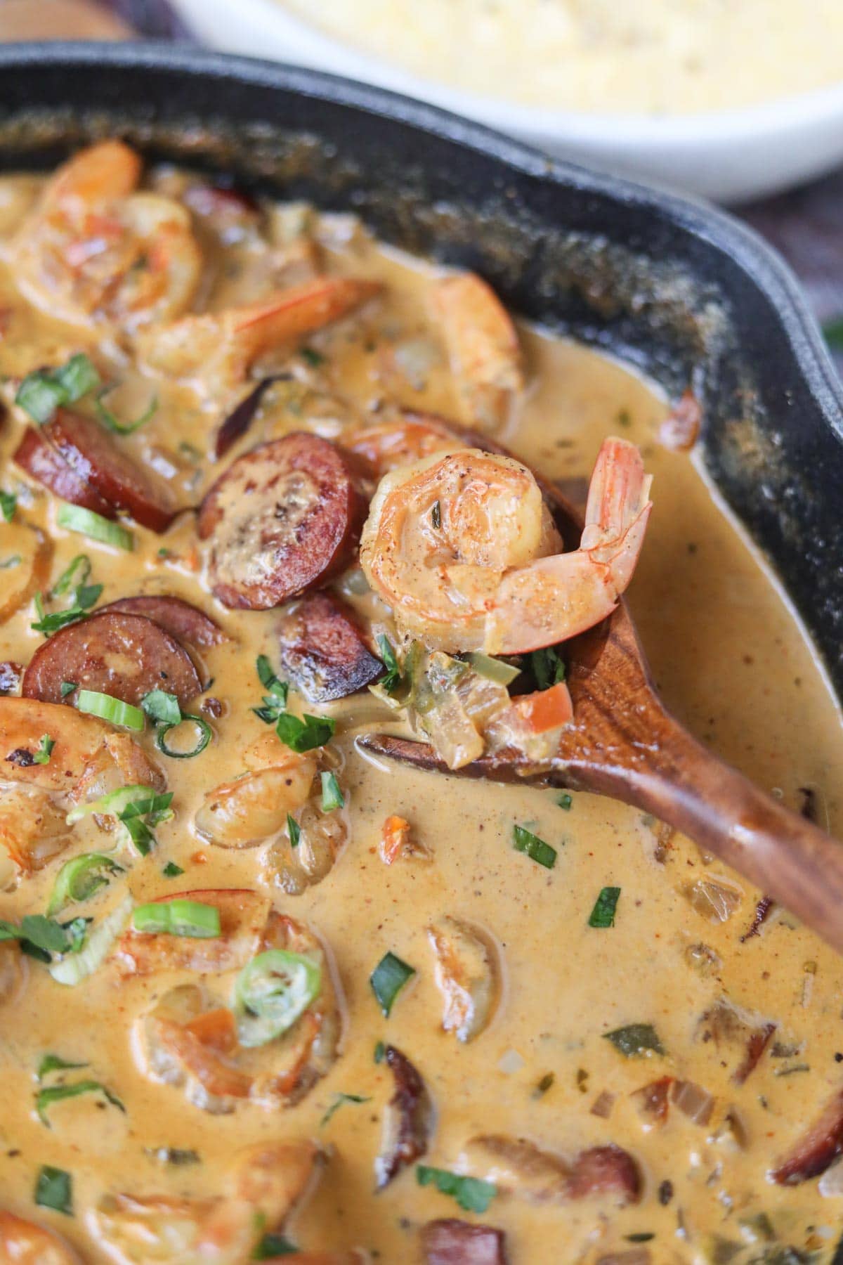 shrimp and grits sauce in a cast-iron skillet.