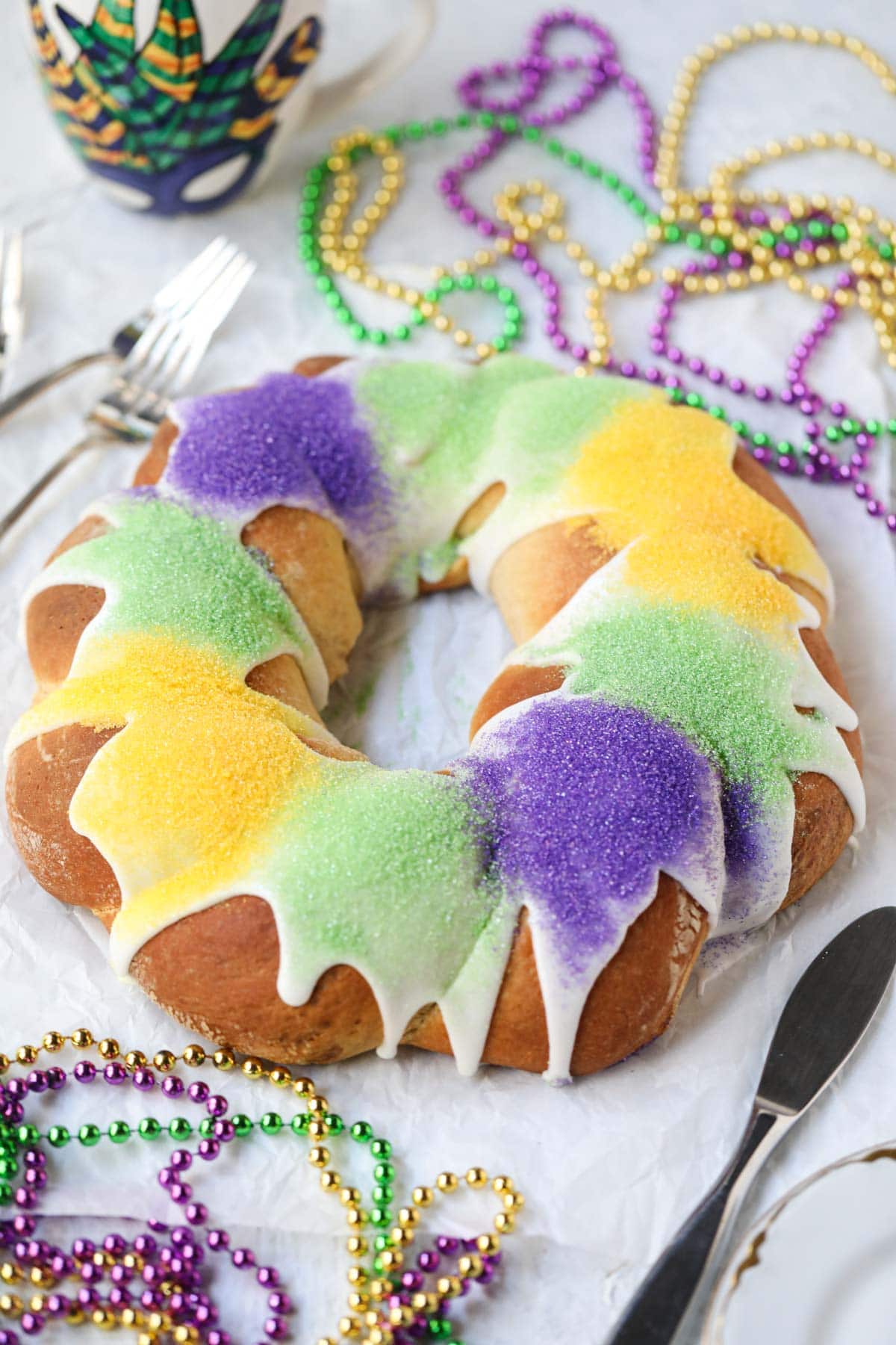 Mardi Gras New Orleans king cake find a white surface.