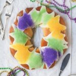 Mardi Gras New Orleans king cake find a white surface.