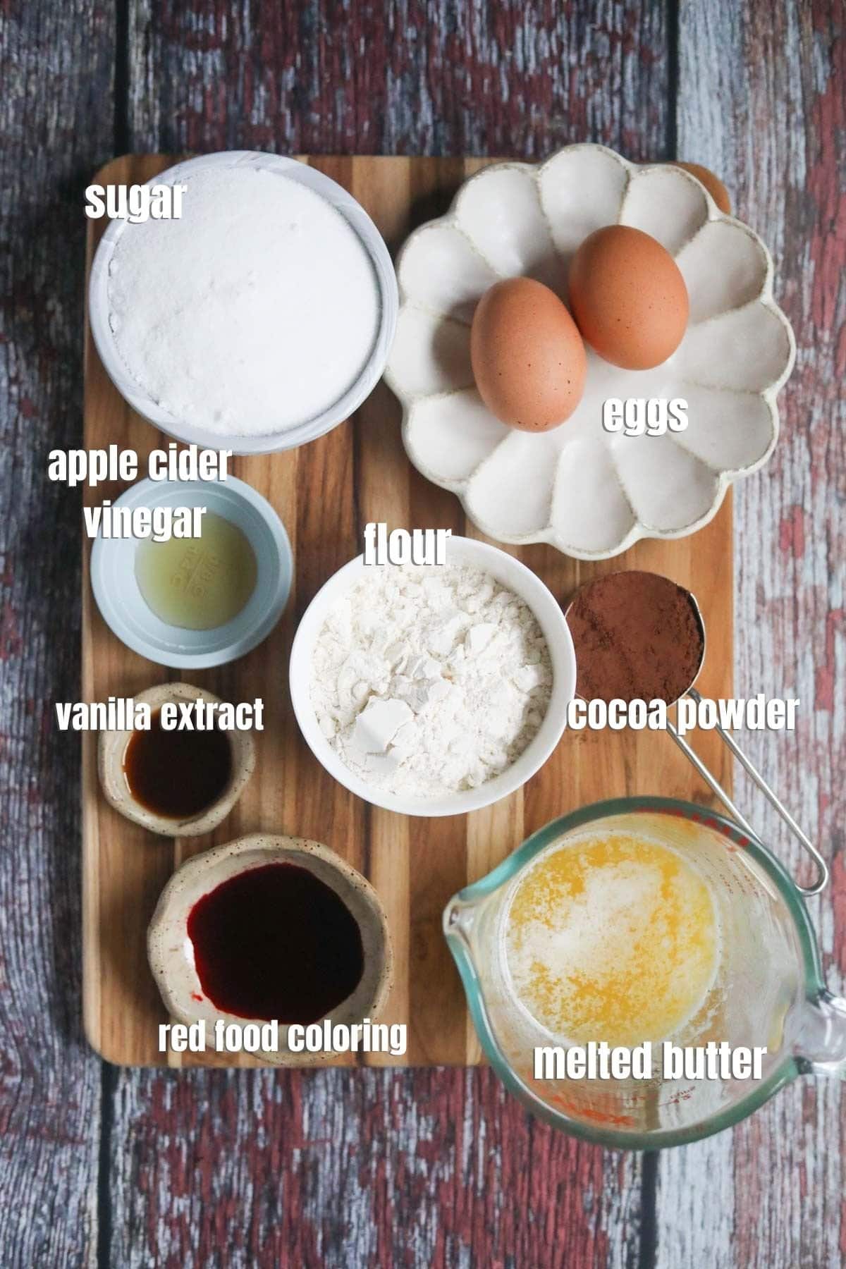 Ingredients for red velvet brownies spread out on a wooden cutting board.
