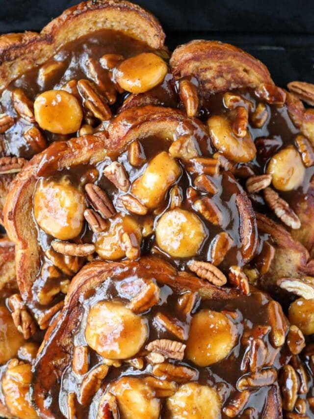 Bananas foster French toast on a black cutting board.