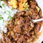 Louisiana ribbons and rice in a white bowl with cornbread.