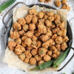 Southern fried okra on a metal tray sitting on a white surface.