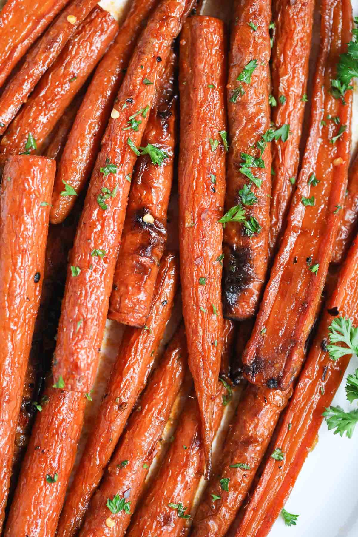 Maple roasted carrots on a white platter.
