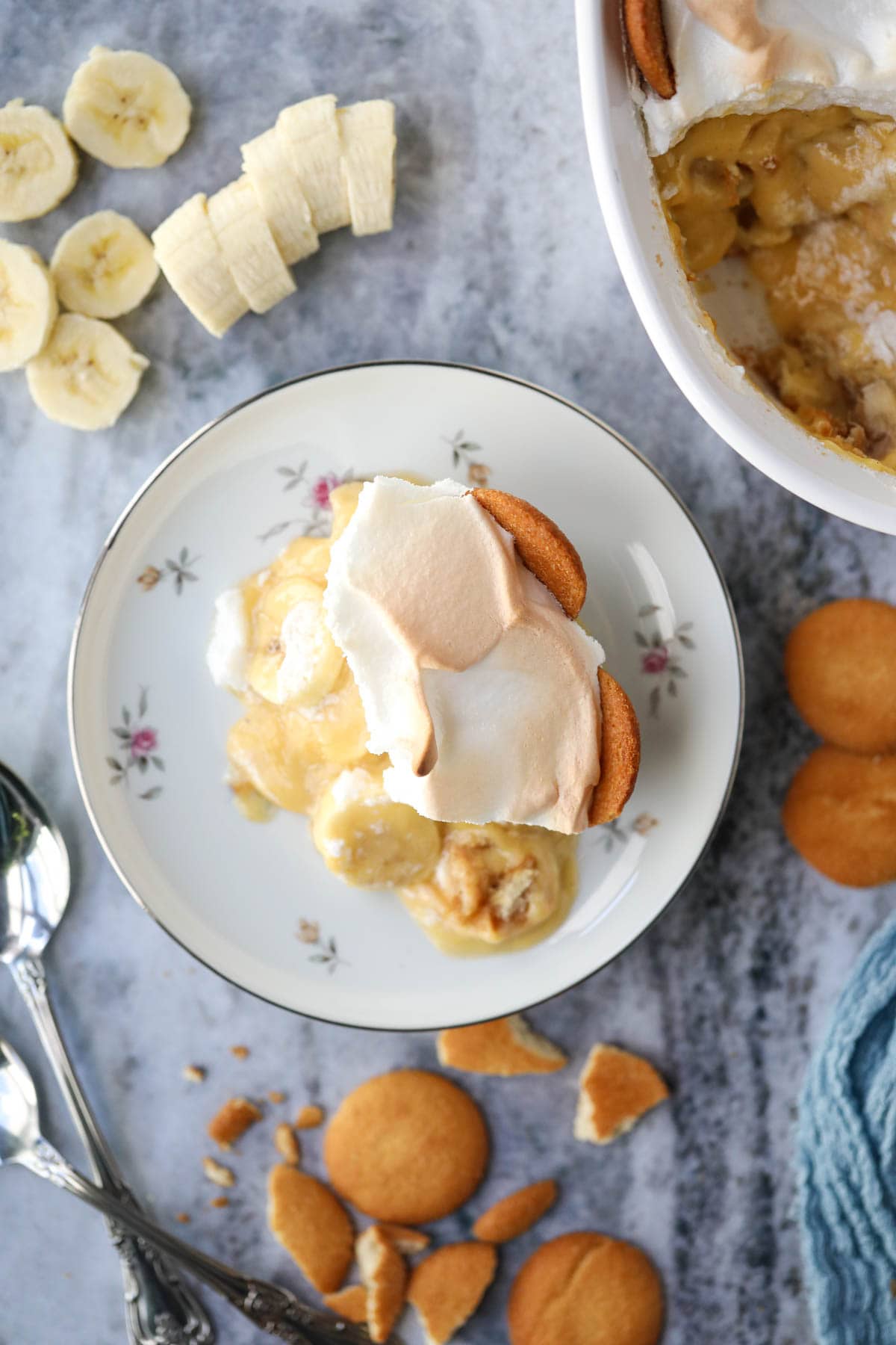 A serving of old-fashioned banana pudding on a white plate.