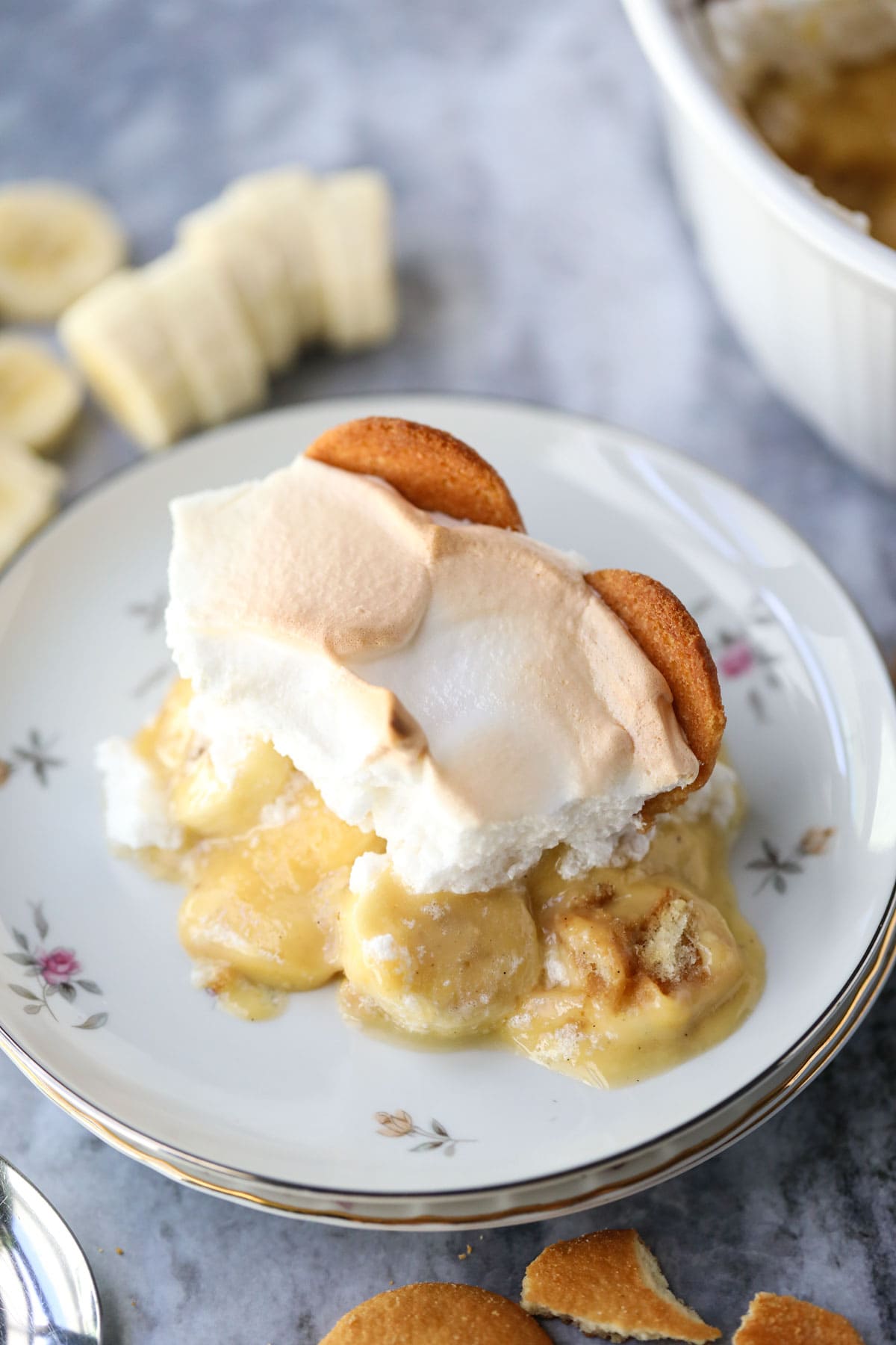 A serving of old-fashioned banana pudding on a white plate.