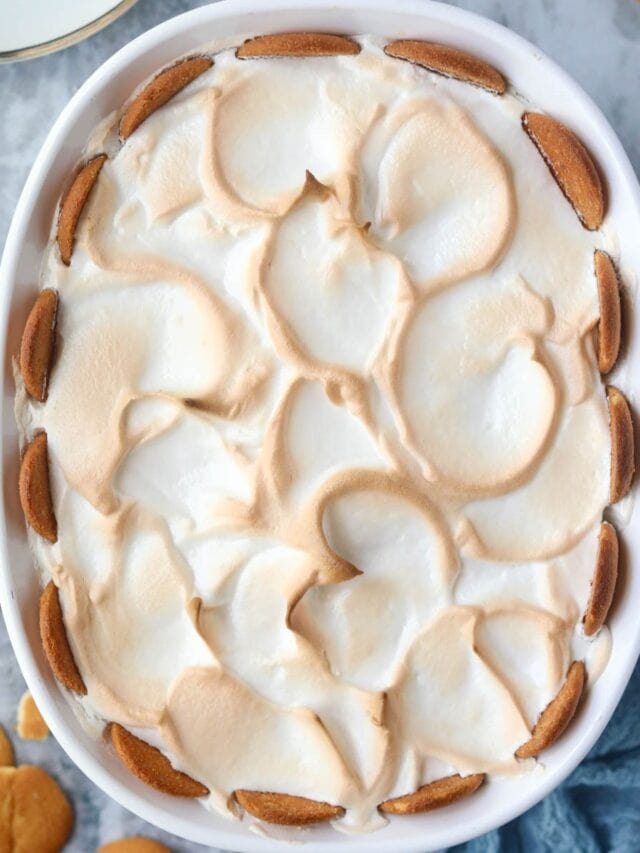 Old-fashioned banana pudding in a white baking dish sitting on top of a gray surface.