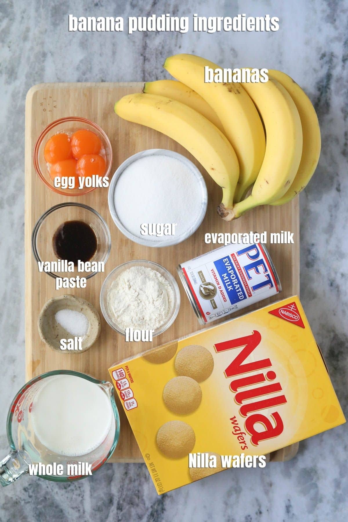 Old-fashioned banana pudding ingredients arranged on a wooden cutting board.