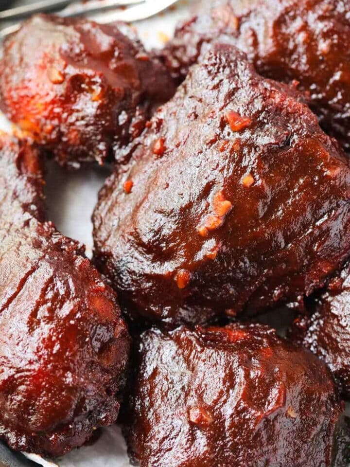 Oven baked barbecue chicken on a metal platter.