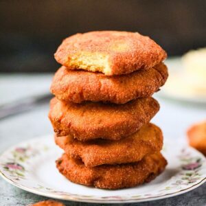 A stack of hot water cornbread patties on a plate.