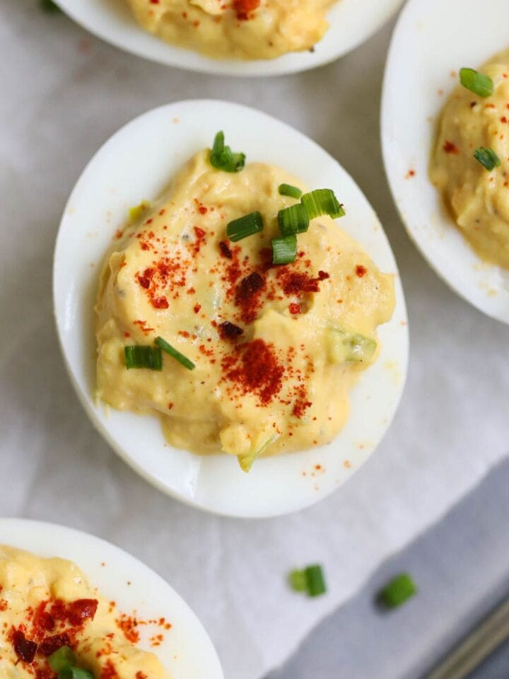 Southern deviled eggs arranged on a silver platter.