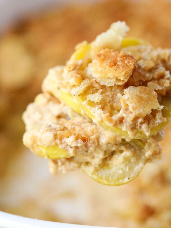 Southern squash casserole on a silver spoon.