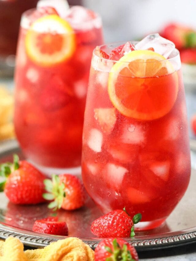 Strawberry sweet iced tea in tall glasses on a metal serving tray.