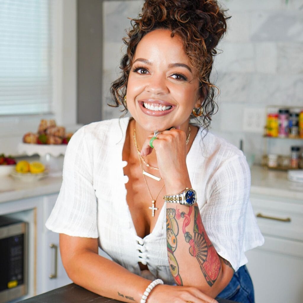 Ashley boyd leaning over counter in the kitchen.