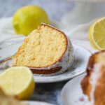 Slice of moist lemon Bundt cake on a white plate.