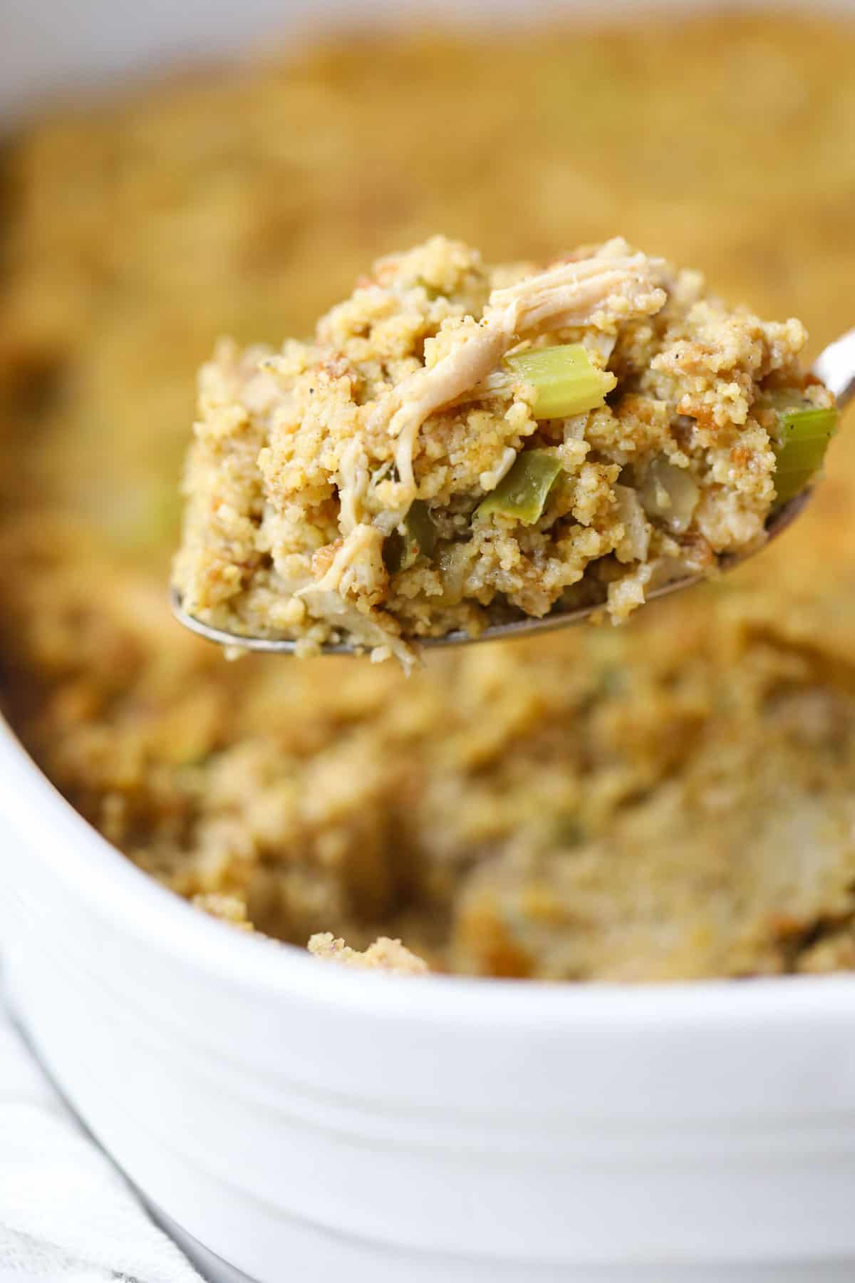 Southern chicken and dressing on a serving spoon to show texture.