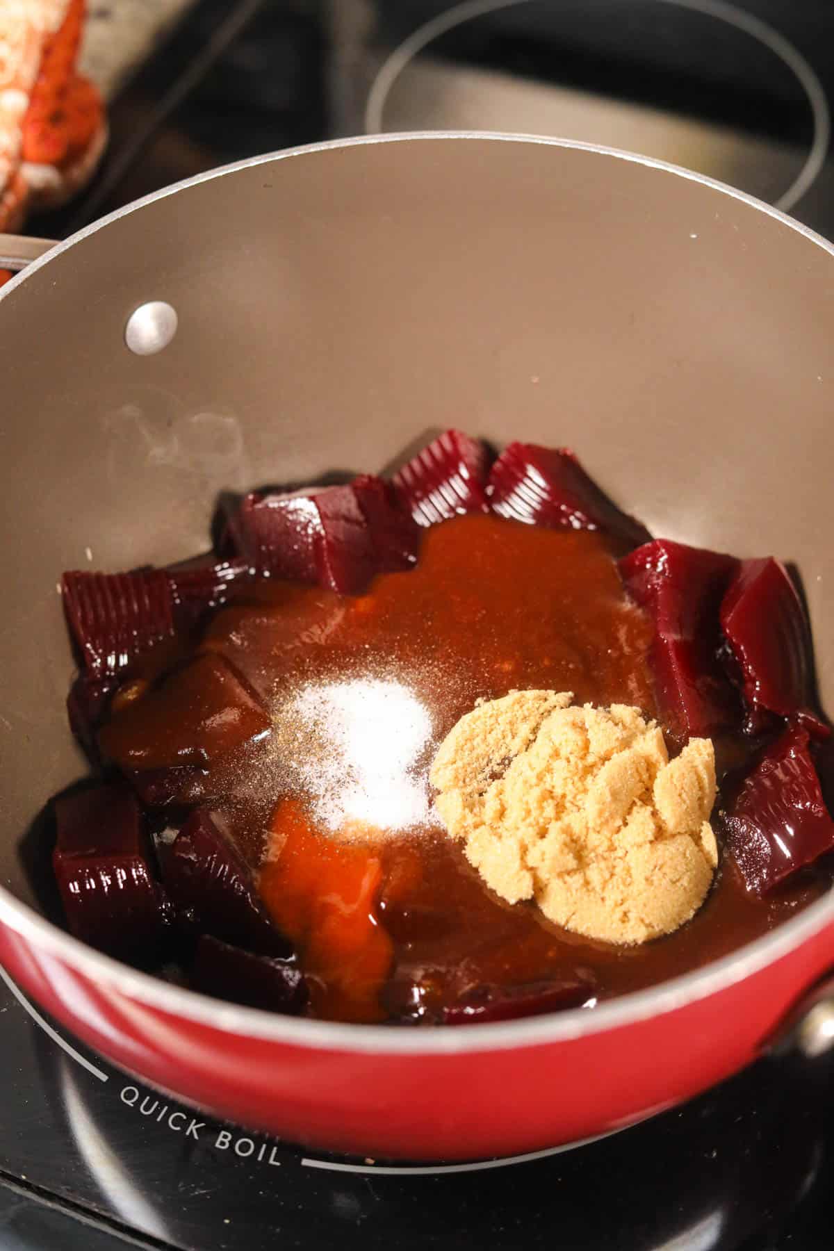 Cranberry barbecue sauce for meatballs, simmering in a sauce pan.