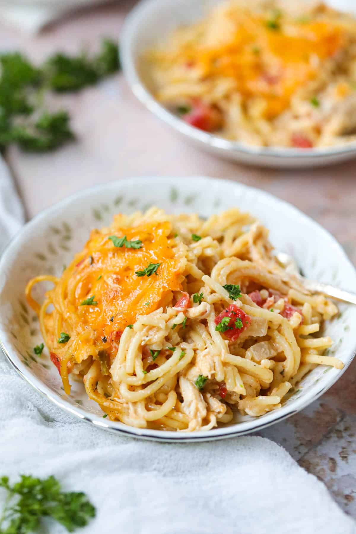 Chicken spaghetti with rotel in a white bowl.