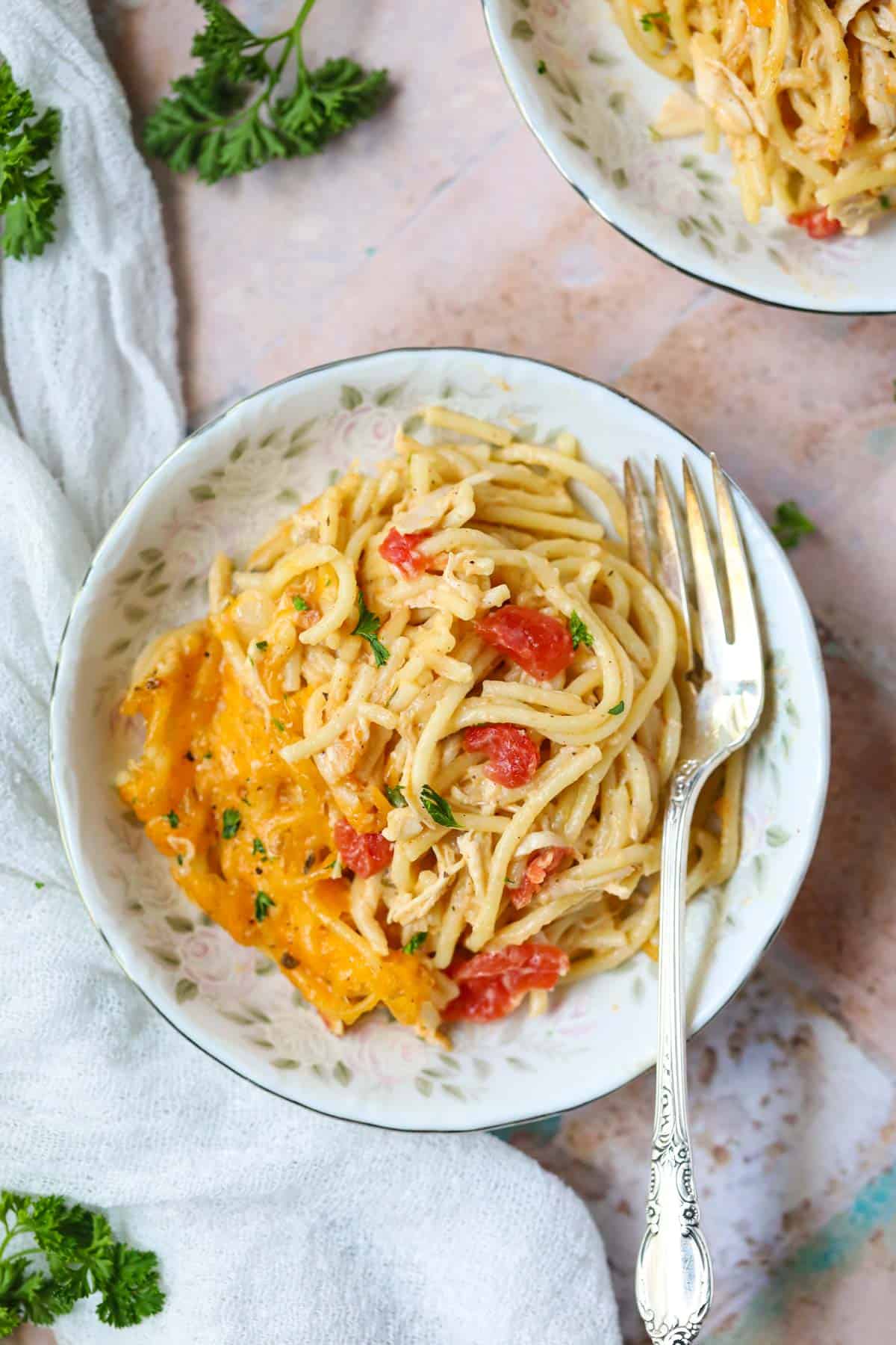 Chicken spaghetti with rotel in a white bowl.
