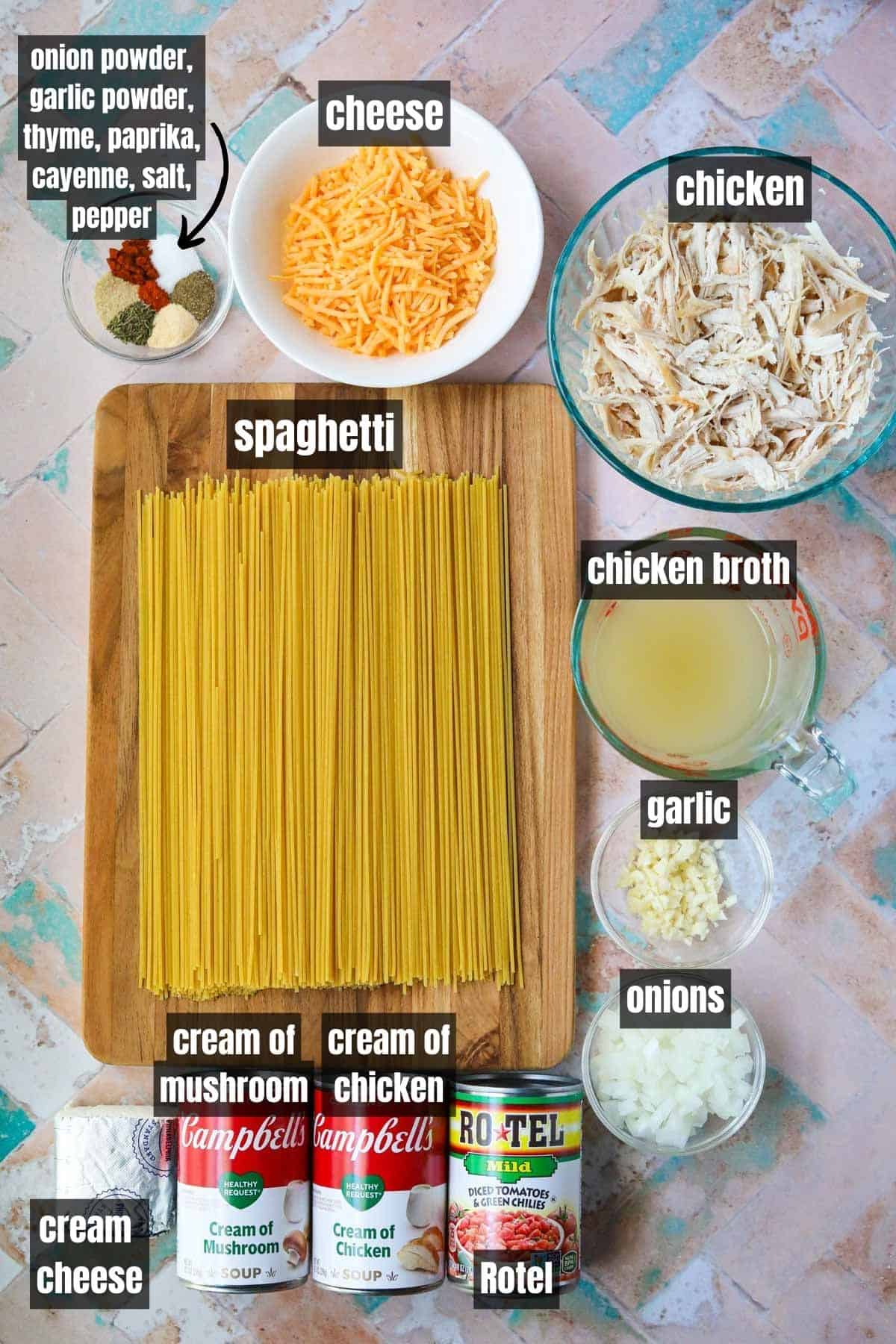 Ingredients for making chicken spaghetti with rotel arranged on a tan tile surface.