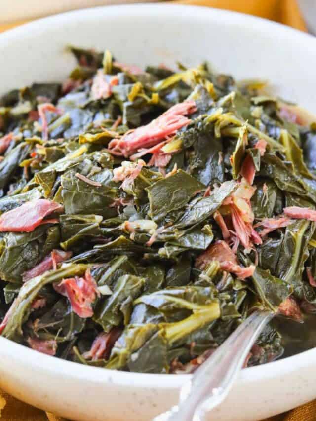 Southern collard greens in a white bowl with a silver fork.