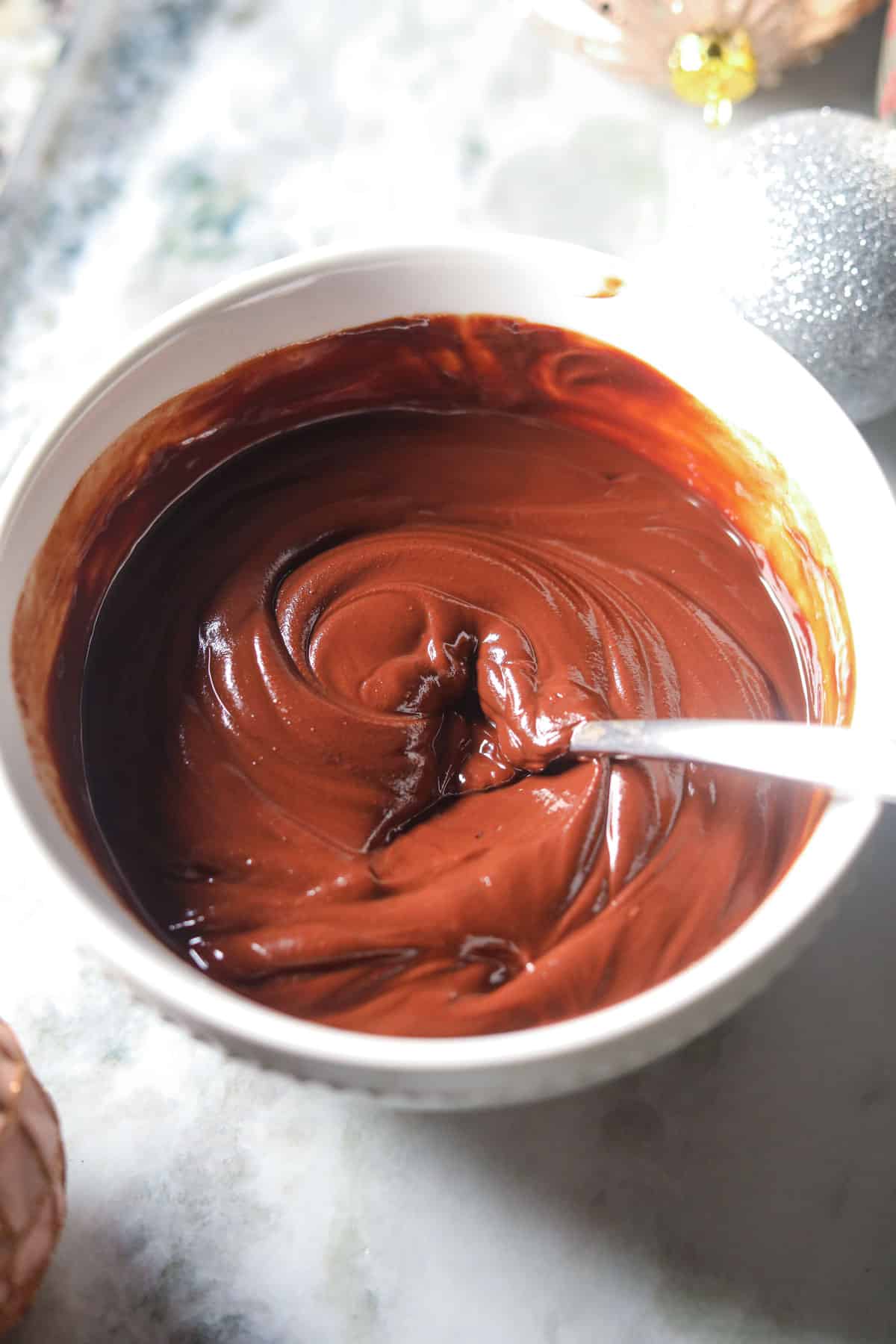 Melted chocolate and butter in a white bowl.