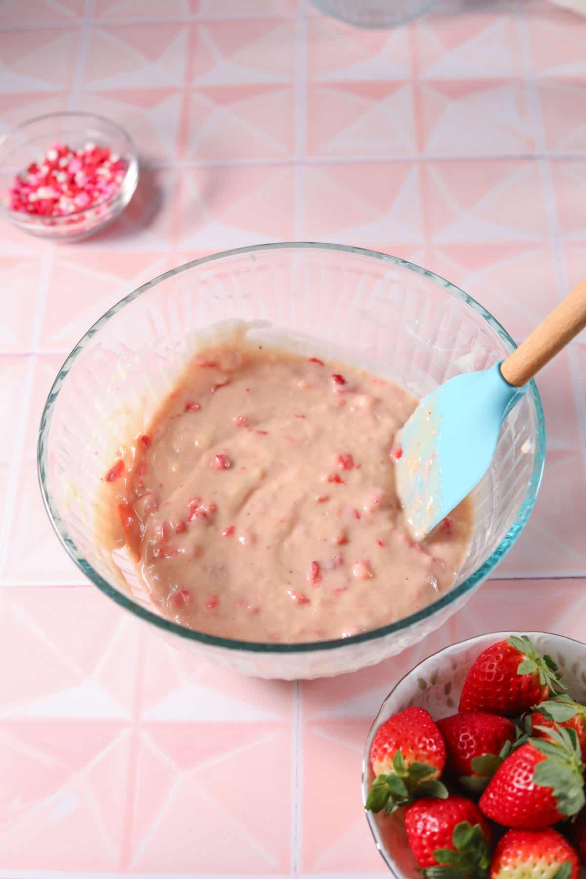 Baked strawberry donut batter in a glass mixing bowl.