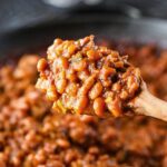 baked beans with ground turkey on a wooden spoon.