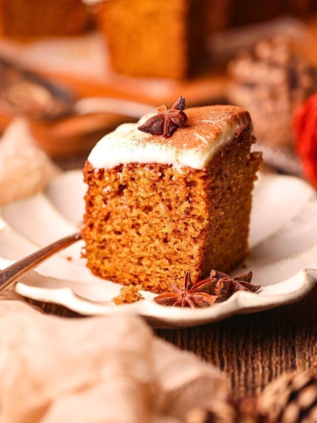 A slice of pumpkin snack cake on a white dessert plate.