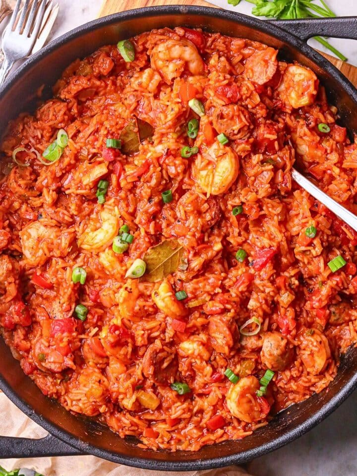 A pan of shrimp and sausage jambalaya, packed with vibrant colors, bold Cajun spices, and hearty ingredients on a tabletop.