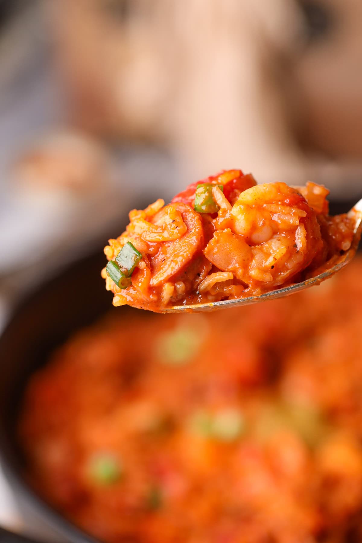 Shrimp and sausage jambalaya on a serving spoon.