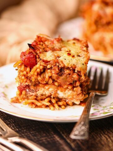 A serving of million dollar spaghetti on a white plate.