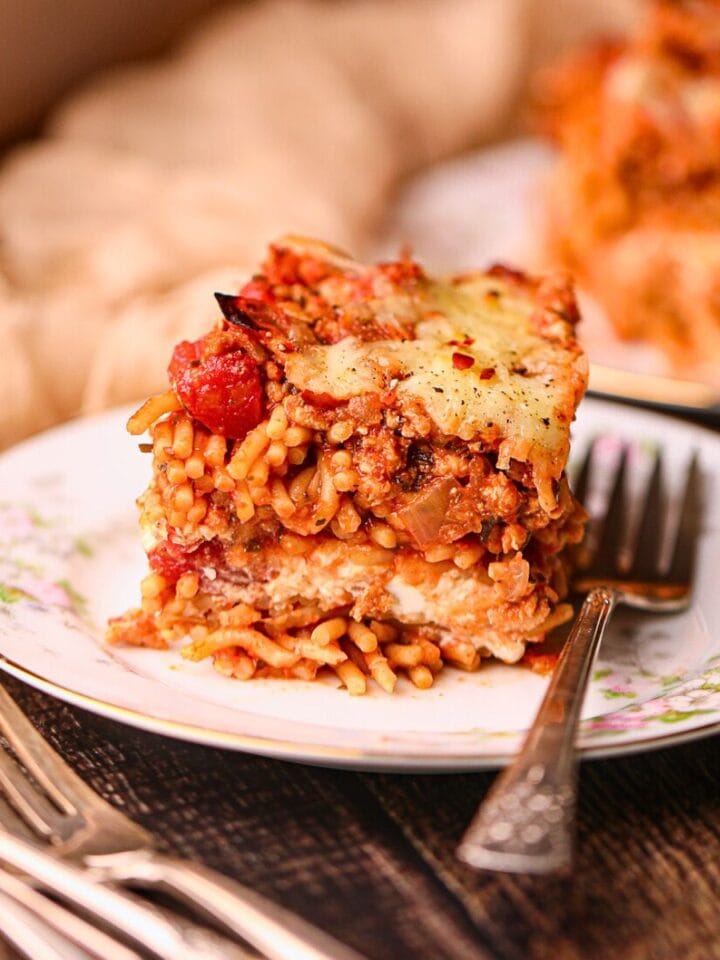 A serving of million dollar spaghetti on a white plate.