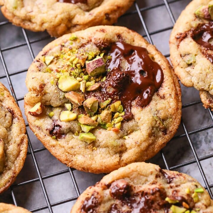 Brown butter pistachio chocolate chip cookies on a baking sheet.