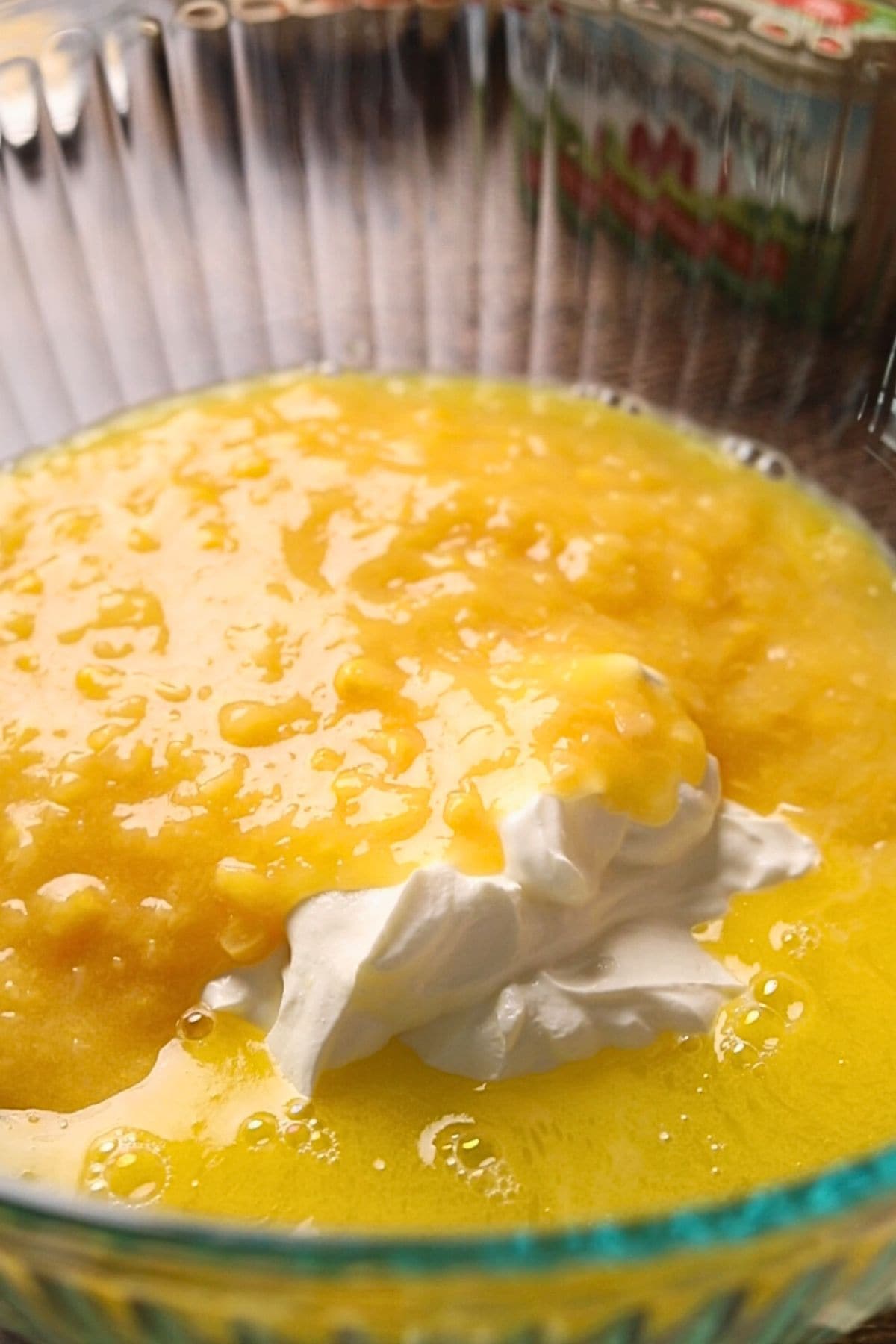 What ingredients for creamy cheesy corn bread casserole in a mixing bowl.