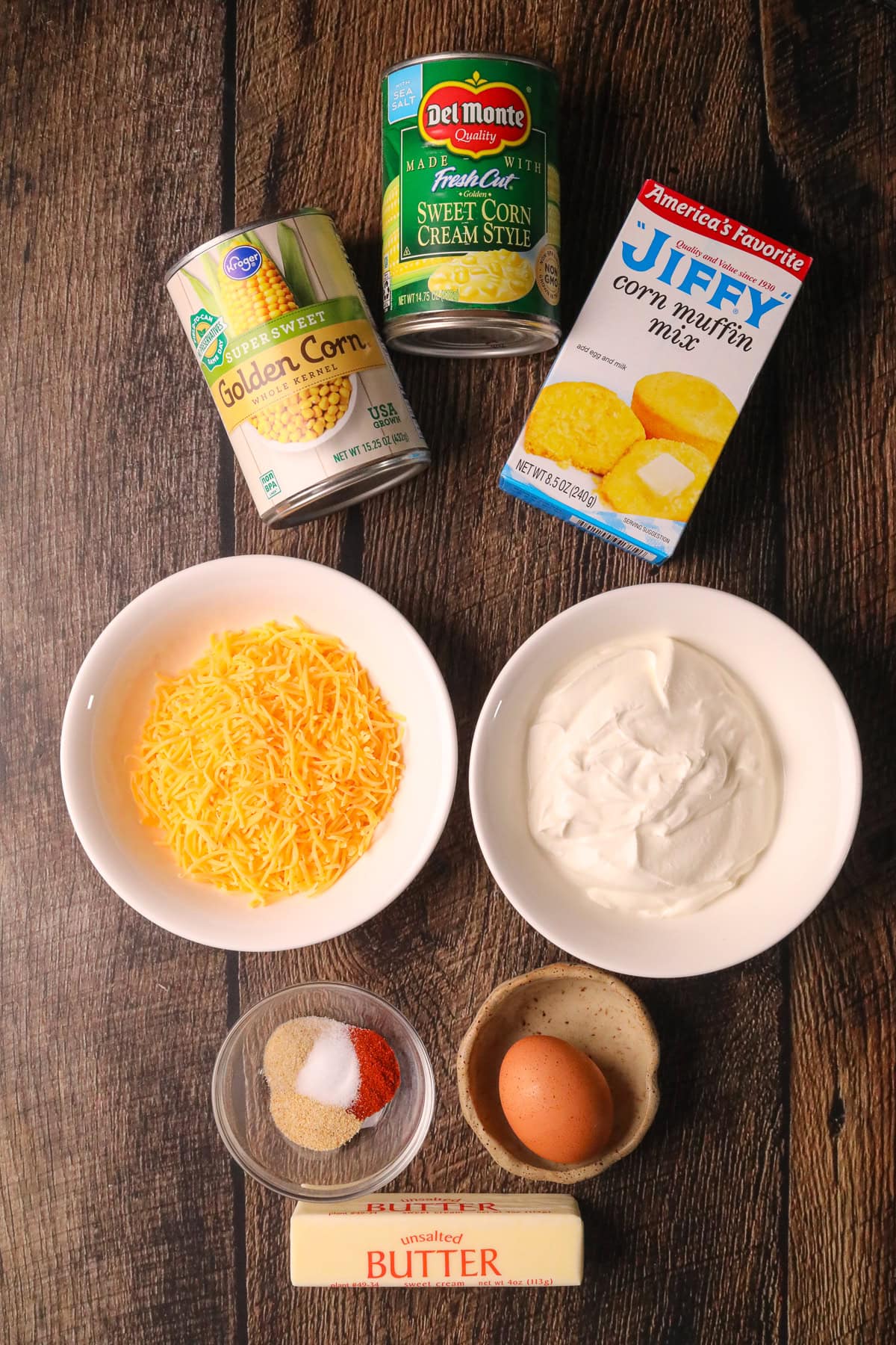 Creamy cheesy cornbread casserole ingredients on a table.