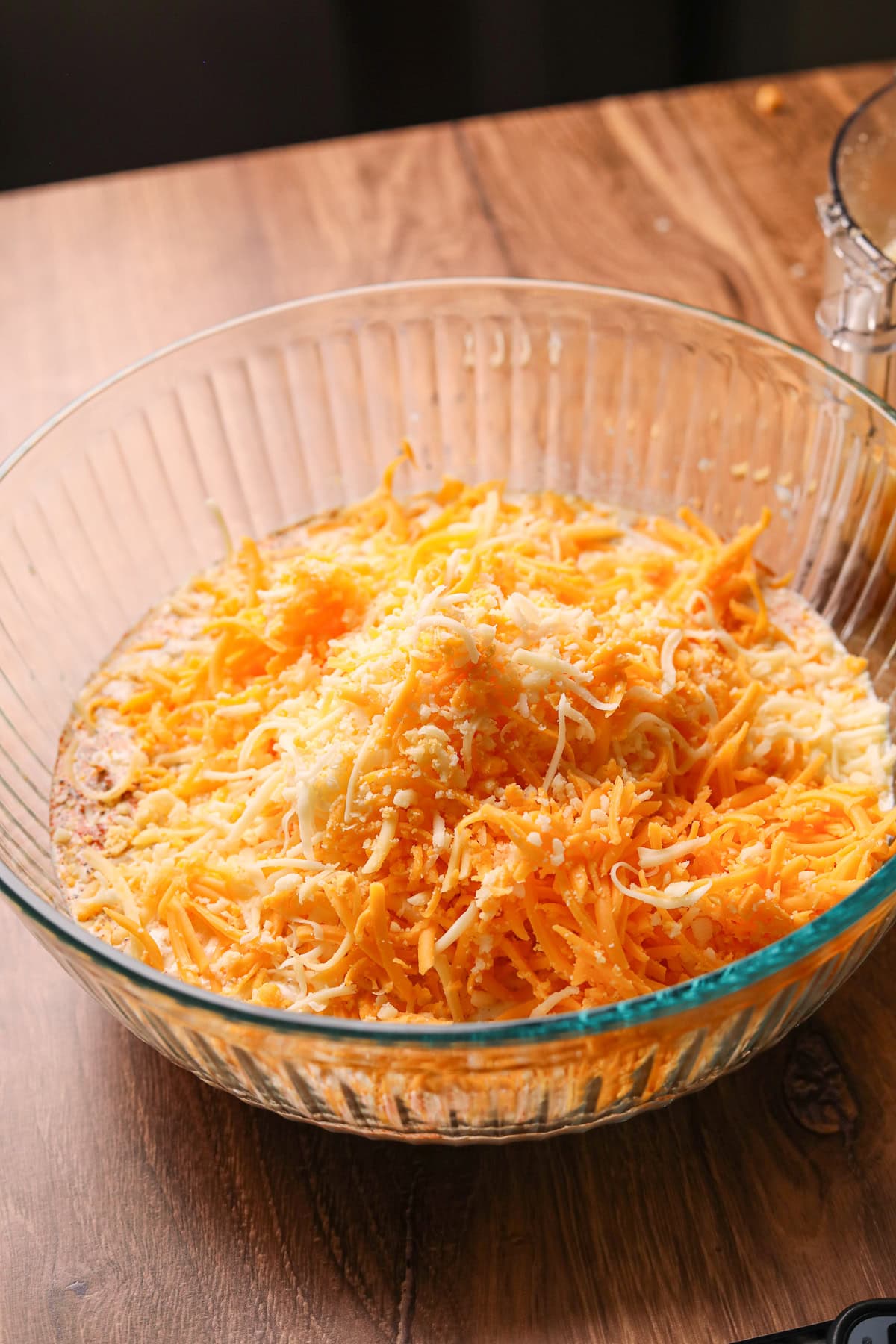 Cheese and cream mixture for southern baked mac & cheese in a large mixing bowl.