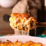 A serving of creamy southern baked mac & cheese on a serving spoon.