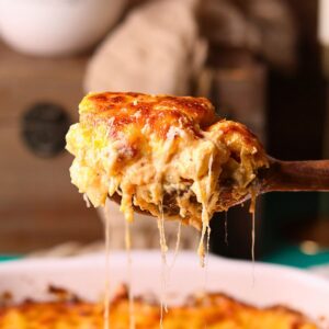 A serving of creamy southern baked mac & cheese on a serving spoon.