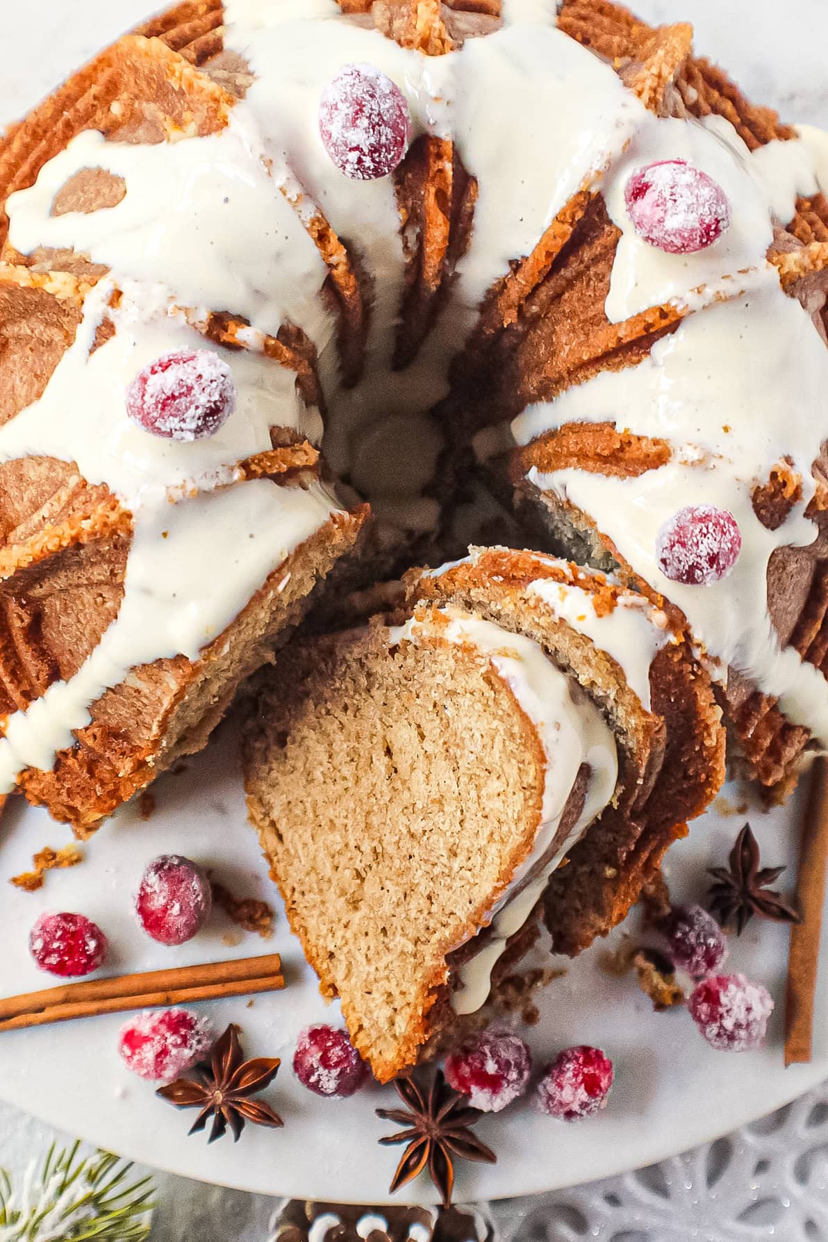 Spiced Bundt cake with maple cream cheese glaze on a cake plate.
