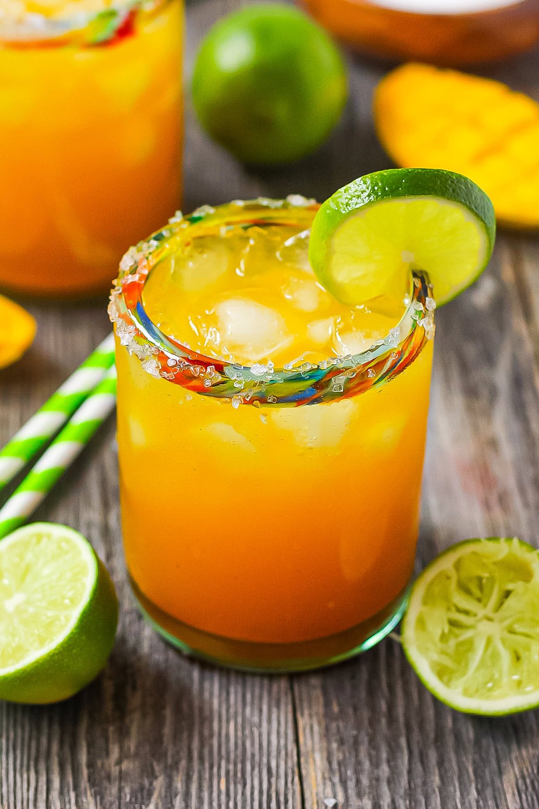 Tropical mango citrus Mocktail in a glass with a lime wedge.