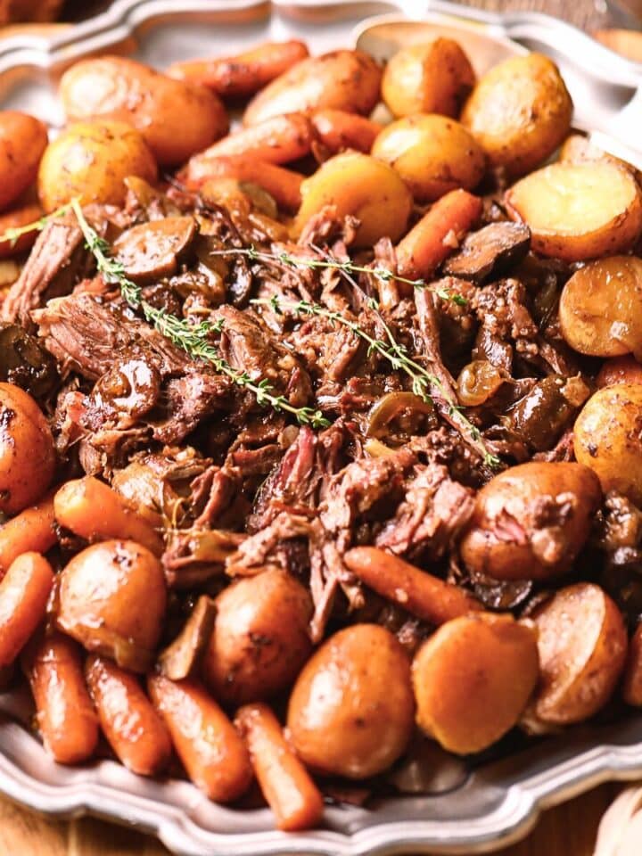 Ultimate Dutch oven pot roast with vegetables on a serving platter.
