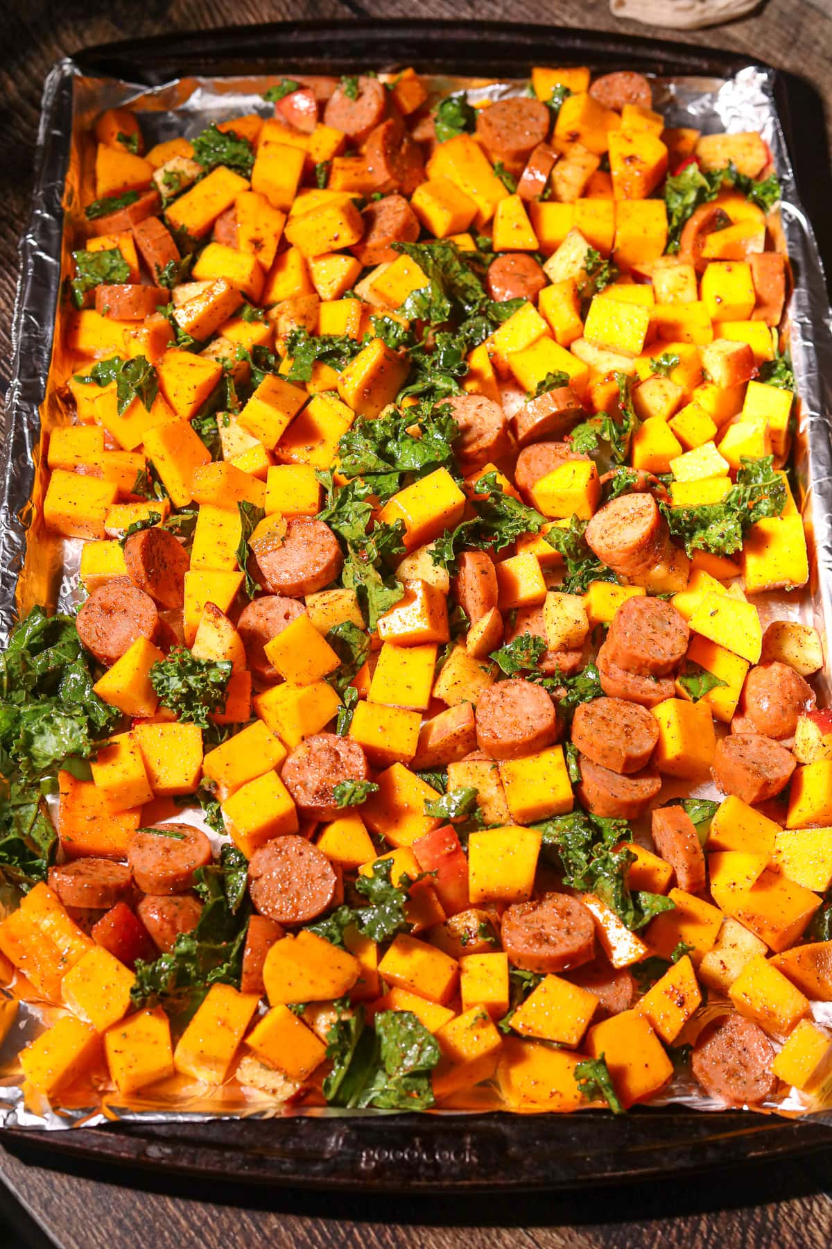 Chicken sausage and butternut squash sheet pan meal before going into the oven.