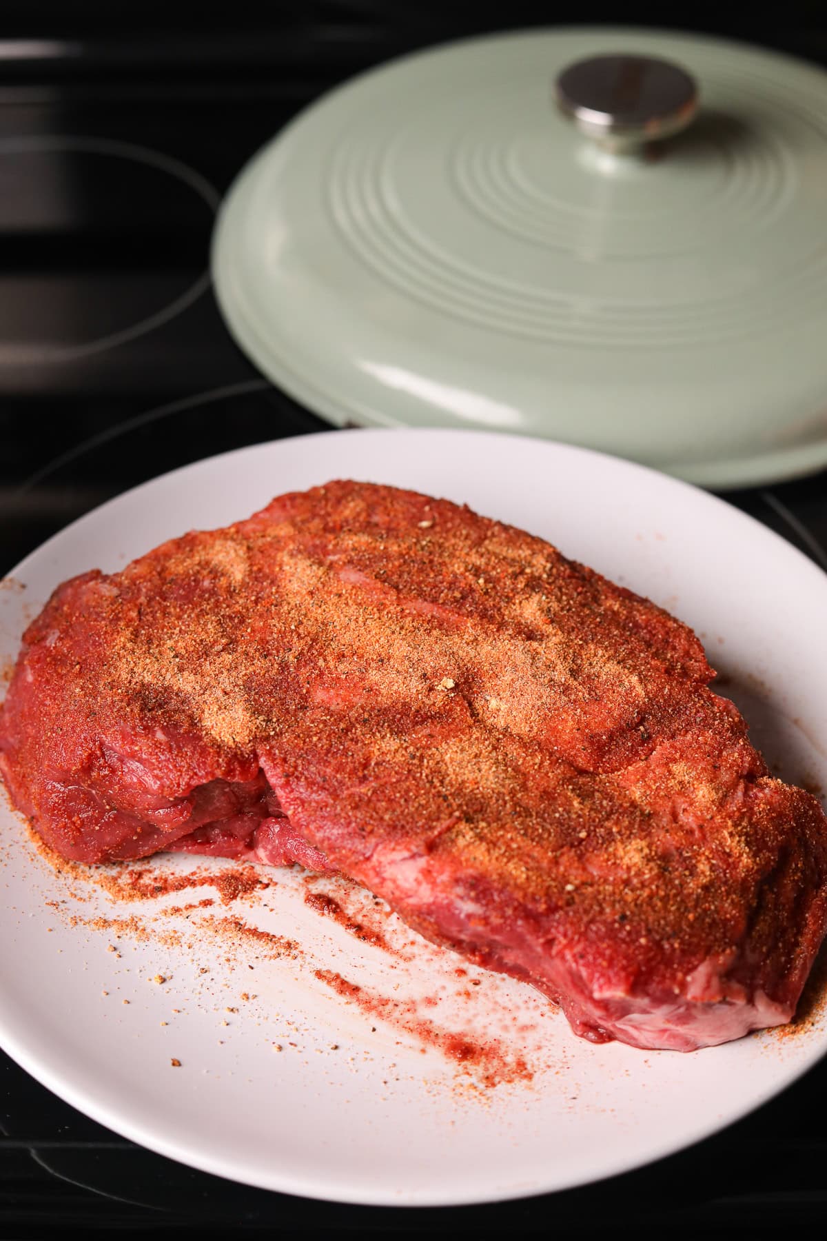 Seasoned chuck roast on a plate.
