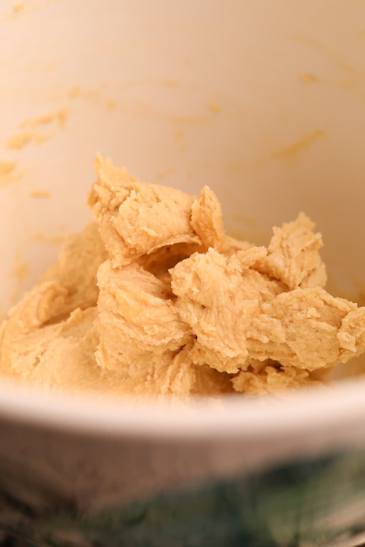 Creamed, butter, and sugars in the bowl of a stand mixer.